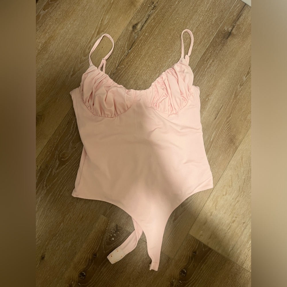 Isabella’s cabinet baby pink bodysuit!